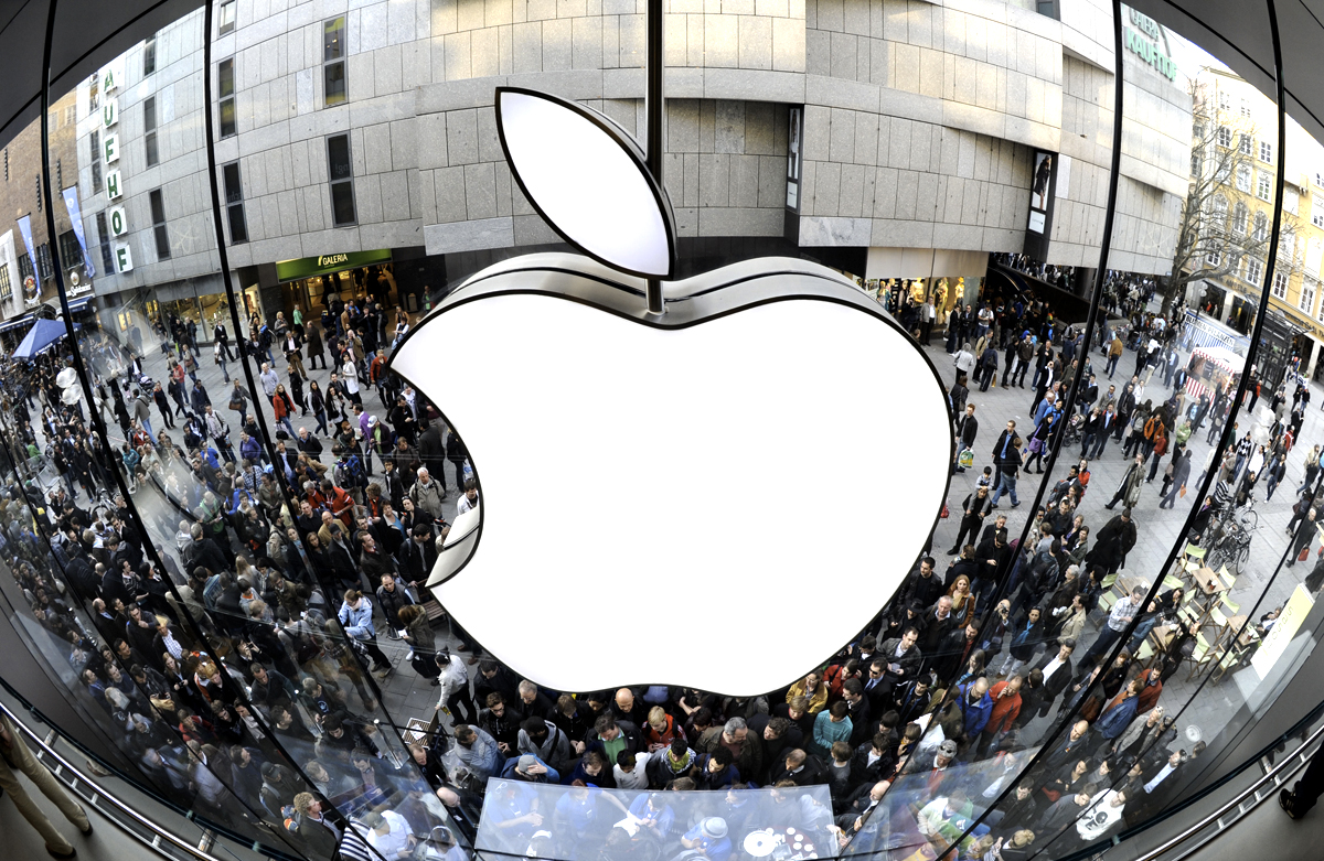 A giant Apple logo can be seen as customers wait for the new Apple iPad 2 in front of the Apple-store in the southern German city of Munich on March 25, 2011. Apple's eagerly-awaited iPad 2 went on sale in 25 countries in Europe, Oceania and the Americas, two weeks after its official launch in the United States. AFP PHOTO / CHRISTOF STACHE (Photo credit should read CHRISTOF STACHE/AFP/Getty Images)